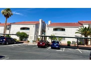 Condominium complex with covered parking, red tile roof, and neutral-toned stucco exterior at 2725 S Nellis Blvd # 1158, Las Vegas, NV 89121