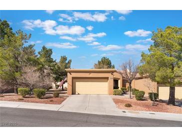 Inviting single-story home with desert landscaping, mature trees, and an attached two-car garage at 2735 Faiss Dr, Las Vegas, NV 89134