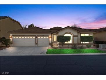 Charming single-story home featuring a three-car garage and well-manicured landscaping at 283 Parisian Springs Ct, Las Vegas, NV 89148