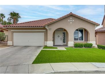 Charming single-story home with a well-manicured lawn, arched entryway, and a two-car garage at 3021 Scenic Valley Way, Henderson, NV 89052