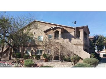 Multi-level apartment building in a landscaped community with mature trees on a bright, sunny day at 5750 E Hacienda Ave # 202, Las Vegas, NV 89122