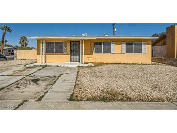 Single story home with a rock yard and minimal landscaping at 6120 Cairo Cir, Las Vegas, NV 89107