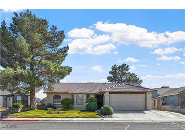 Charming single-story home featuring a well-manicured lawn and mature shade tree at 6217 Sadler Dr, Las Vegas, NV 89130