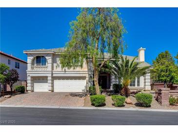 Charming two-story home featuring a three-car garage, landscaped yard and a brick-paved driveway at 7623 Calm Passage Ct, Las Vegas, NV 89139