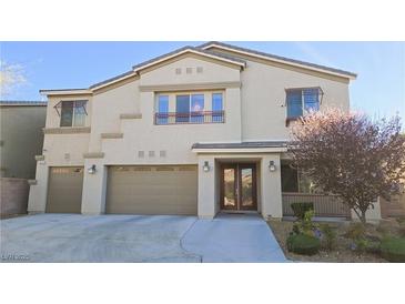 Charming two-story home featuring a three-car garage and a beautifully landscaped front yard at 8223 Saddleback Ledge Ave, Las Vegas, NV 89147