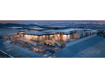 Stunning modern home with desert landscaping and city views at twilight at 9 Stonecutter Ct, Henderson, NV 89012