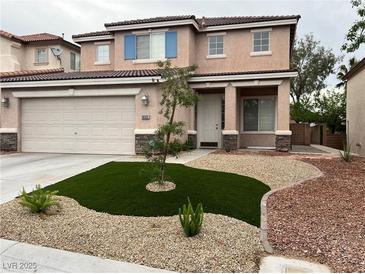 Charming two-story home with a two-car garage and low-maintenance front yard at 10332 George Hart Ct, Las Vegas, NV 89129
