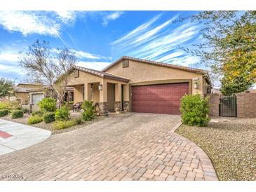 Beautiful single-story home featuring a brick driveway and a two-car garage at 1859 Hatfields Ct, Henderson, NV 89044