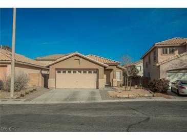 Inviting single story home features a two car garage and low maintenance desert landscaping at 204 Mchenry St, Las Vegas, NV 89144