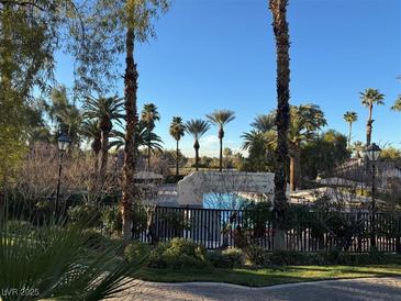 A beautiful community pool with tropical landscaping creates a relaxing environment for residents at 2050 W Warm Springs Rd # 4223, Henderson, NV 89014