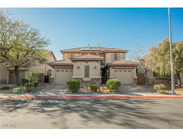 Charming home featuring a well-manicured front yard and attached two-car garages with a shared facade at 3717 Moonshine Falls Ave, North Las Vegas, NV 89085
