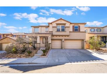 Charming two-story home featuring a two-car garage, manicured landscaping, and a welcoming entrance at 63 Crescent Palm Ct, Henderson, NV 89002