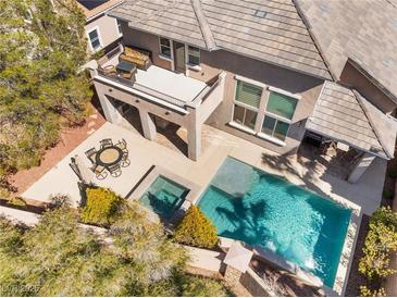 Aerial view of backyard featuring a pool, jacuzzi, dining area, and balcony with lounge seating at 837 Roseberry Dr, Las Vegas, NV 89138