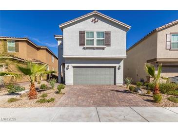 Charming two-story home with a brick driveway and desert landscaping at 8446 Vacarez Dr, Las Vegas, NV 89149