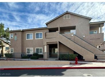 Beautiful tan building with a welcoming entrance and stairs leading to upper units at 2100 Quarry Ridge St # 106, Las Vegas, NV 89117