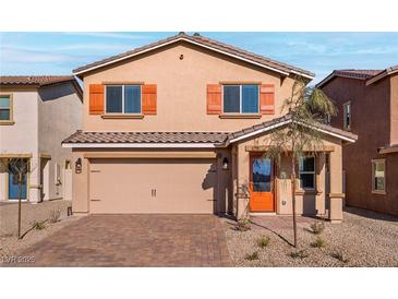 Charming two-story home with a two-car garage, desert landscaping, and stylish orange shutters and door at 4224 Golden Sol St, North Las Vegas, NV 89032