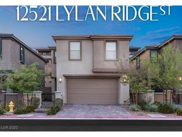 Charming two-story home featuring a neutral color palette, two car garage, and well-maintained landscaping at 12521 Lylan Ridge St, Las Vegas, NV 89138