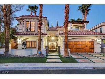 Elegant two-story stucco home featuring a red tile roof, gated entry, and a spacious two-car garage at 2508 Monarch Bay Dr, Las Vegas, NV 89128