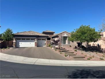Charming single-story home featuring a two-car garage, landscaped front yard, and tiled roof at 2809 Proust Ct, Henderson, NV 89044