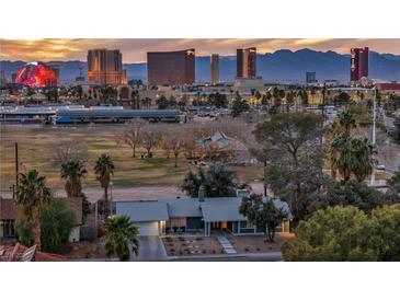 Aerial view of the home showcases nearby park and the vibrant Las Vegas skyline at 3731 Spencer St, Las Vegas, NV 89119