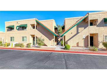 A two-story apartment building showing the walkway and stairs, with a green awning and red trim around the roof at 6750 Del Rey Ave Ave # 226, Las Vegas, NV 89146