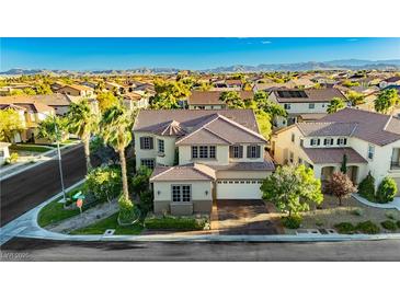 Expansive two-story home with desert landscaping, mountain views, and tile roof in quiet neighborhood at 7427 Tomahawk Bend Ave, Las Vegas, NV 89113
