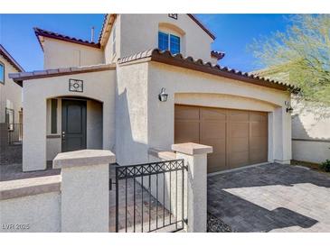 Charming two-story home featuring a stucco exterior, brown trim, and a well-maintained front yard at 829 N Water St, Henderson, NV 89011