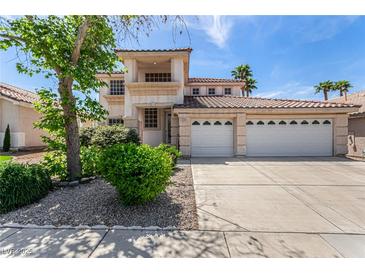 Charming two-story home featuring a three-car garage, landscaped yard, and a sunny sky at 1339 Echo Creek St, Henderson, NV 89052