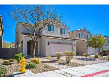 Charming two-story home with desert landscaping, attached two-car garage, and a welcoming front entrance at 5628 Ridgeland St, North Las Vegas, NV 89031