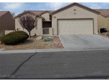 Charming single-story home features a well-maintained front yard and attached two-car garage at 7745 Fruit Dove St, North Las Vegas, NV 89084