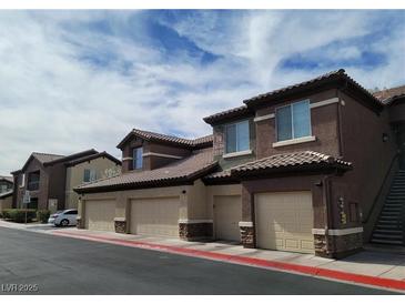 Attractive condo community with attached garages, brown stucco, and tiled roofs at 8324 W Charleston Blvd # 2033, Las Vegas, NV 89117