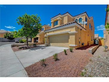 Charming two-story home featuring a well-maintained front yard and attached two-car garage at 9012 Old River Ave, Las Vegas, NV 89149
