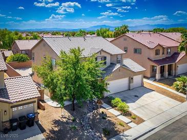 Two-story home showcasing manicured landscaping and a two-car garage at 2305 Dalton Ridge Ct, North Las Vegas, NV 89031
