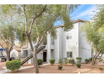 Charming two-story home features an exterior staircase and desert landscaping at 2615 W Gary Ave # 1041, Las Vegas, NV 89123