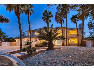 Elegant two-story home with palm trees and manicured landscaping at 3235 S Tioga Way, Las Vegas, NV 89117