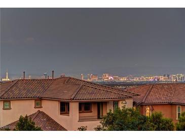 Enjoy breathtaking city views from this home, enhanced by a terracotta tile roof and neutral stucco exterior at 426 Port Reggio St, Las Vegas, NV 89138