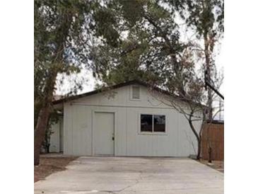 Modest home exterior with a simple design and mature trees at 4341 San Mateo St, North Las Vegas, NV 89032