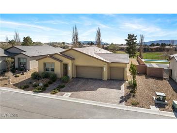 Stunning single-story home featuring a three-car garage and meticulously landscaped front yard in a vibrant community at 5467 Eleganza Ave, Pahrump, NV 89061