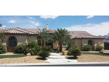 Attractive stucco home featuring a tile roof, stone accents, and desert landscaping at 6120 Matisse Ave, Las Vegas, NV 89131