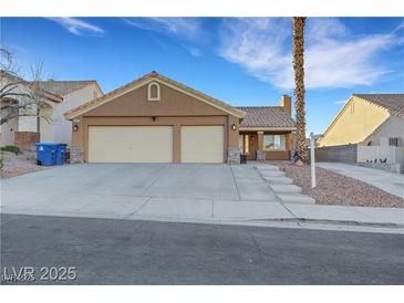 Inviting single-story home features a spacious two-car garage and well-maintained desert landscaping at 686 Covina Dr, Henderson, NV 89002