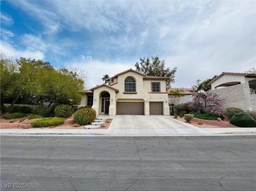 Charming two-story home with a well-manicured lawn and a three-car garage, located in a friendly neighborhood at 3047 Whispering Crest Dr, Henderson, NV 89052