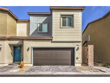 Charming two-story home with a brown two-car garage door and a blue front door at 4234 Lunar Canyon Ave, North Las Vegas, NV 89084