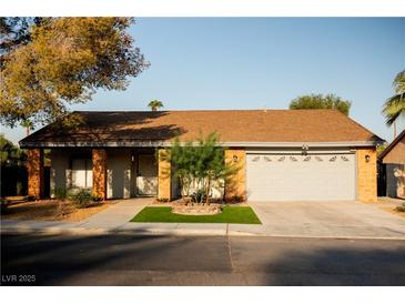 Charming single-story home with a well-manicured lawn and a two-car garage at 4689 Kristen Ln, Las Vegas, NV 89121