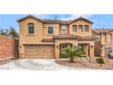 Inviting two-story home with a well-manicured lawn and a two-car garage at 6736 Sugarbird Ct, North Las Vegas, NV 89084