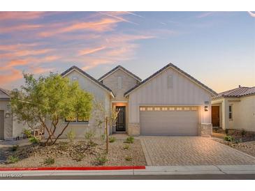 Charming single-story home with a brick driveway and desert landscaping at 9032 Skye Canyon Ranch St, Las Vegas, NV 89166