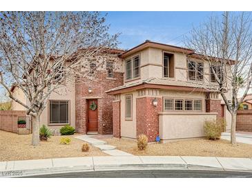 Charming two-story home featuring a brick and stucco exterior with a welcoming front door and well-maintained landscaping at 9204 Brownstone Ledge Ave, Las Vegas, NV 89149