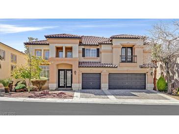 Stunning two-story home featuring a tiled roof, three-car garage, and landscaped front yard at 1401 Via Savona Dr, Henderson, NV 89052