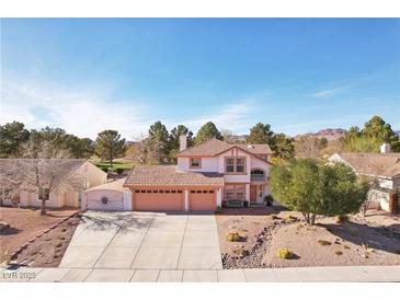 Charming two-story home features a three-car garage, desert landscaping, and a tile roof at 1634 Georgia Ave, Boulder City, NV 89005