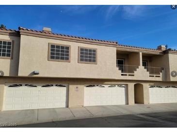 A bright exterior view shows the garages and balcony of this multi-Gathering home at 1851 Hillpointe Rd # 2112, Henderson, NV 89074