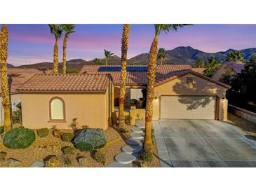 Charming single-story home featuring a well-manicured lawn, desert landscaping, and a spacious two-car garage at 2140 Idaho Falls Dr, Henderson, NV 89044